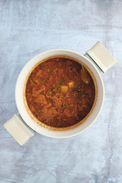 Hamburger soup simmering in a pot.