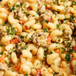Crock-Pot Hamburger Helper with ground beef, macaroni, red bell pepper, and fresh parsley.