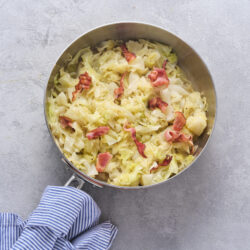 Southern cabbage with bacon pieces in a skillet, ready to serve.