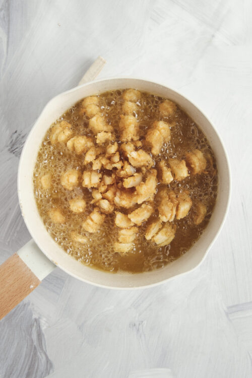 Frying a blooming onion in hot oil.
