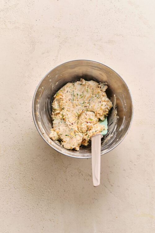 Mixing cream cheese, cheddar, and green onions for the Cheese Ball Recipe.