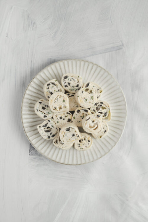 Mexican tortilla roll-ups with a creamy filling and black olives.