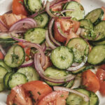 Cucumber Tomato salad on a plate diagonal shot