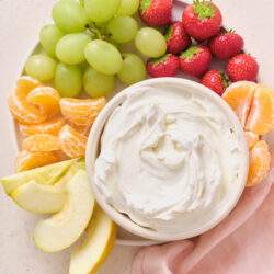 Marshmallow Fruit Dip served with green grapes, strawberries, mandarin oranges, and apple slices.