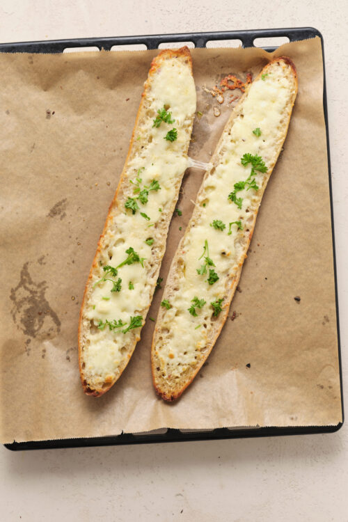 Cheesy garlic bread with melted mozzarella and fresh parsley.