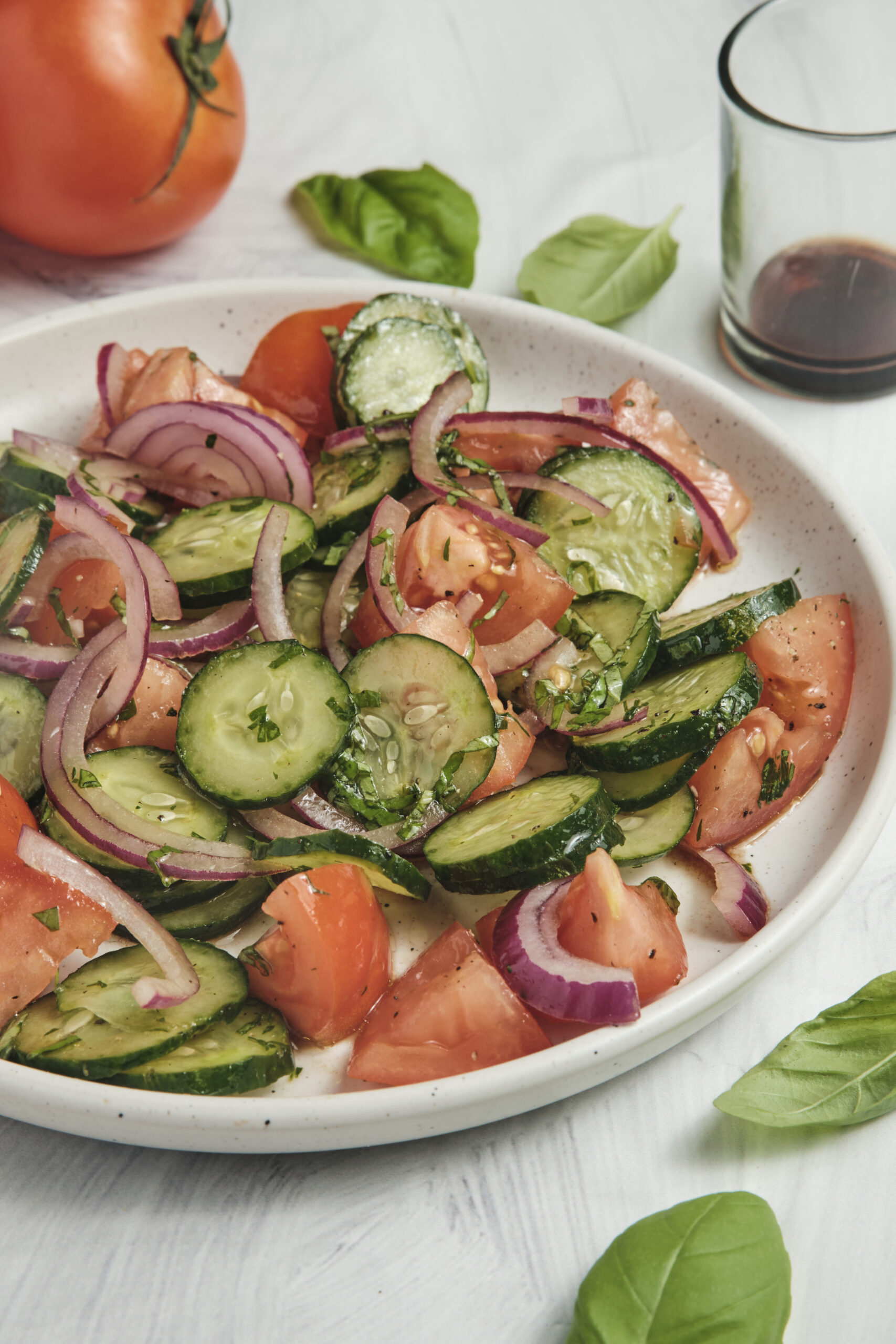 Cucumber Tomato Salad on a plate diagonal shot