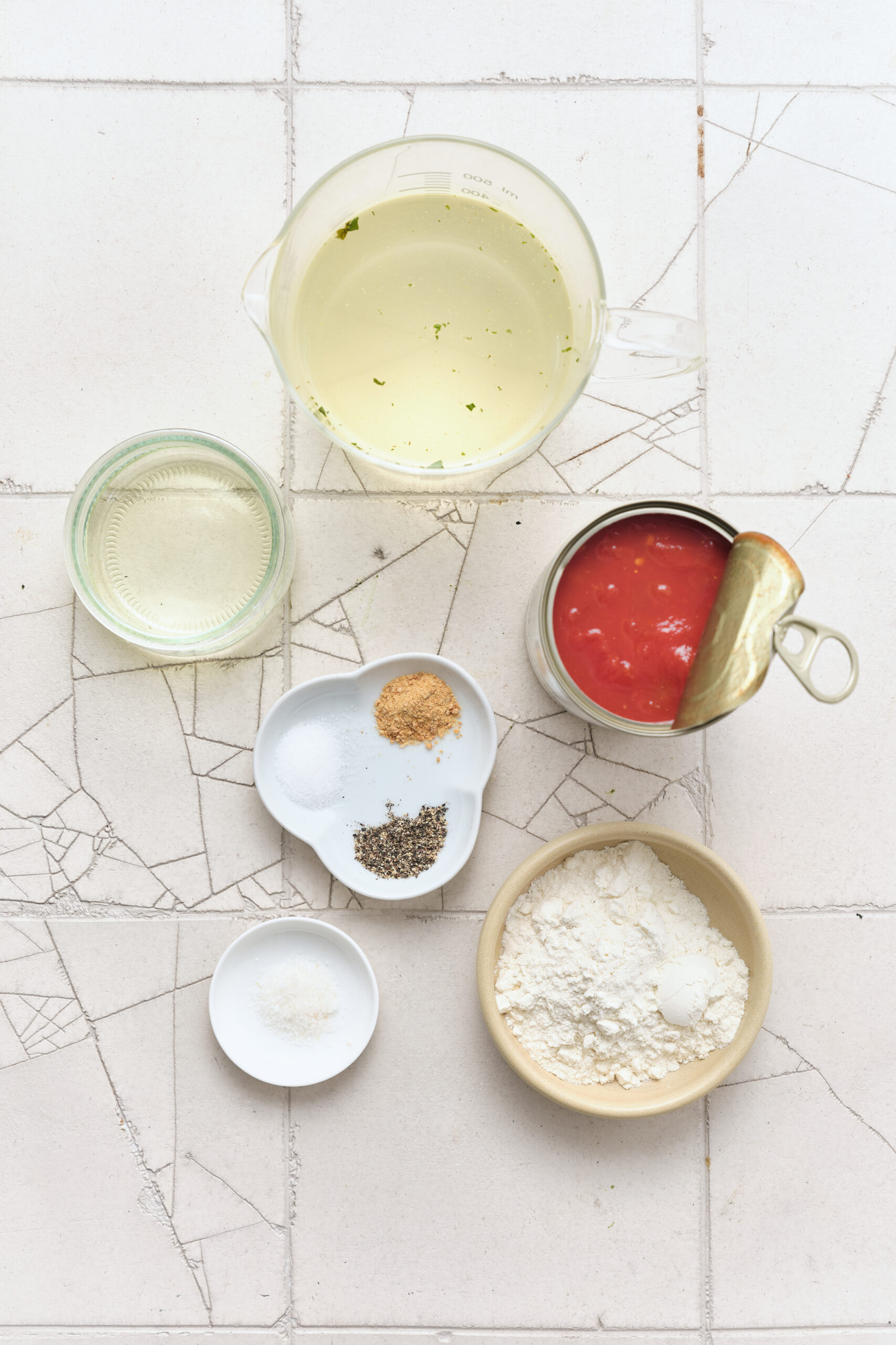 Ingredients for tomato gravy: vegetable oil, all-purpose flour, chicken broth, diced tomatoes, sugar, salt, garlic powder, and black pepper.