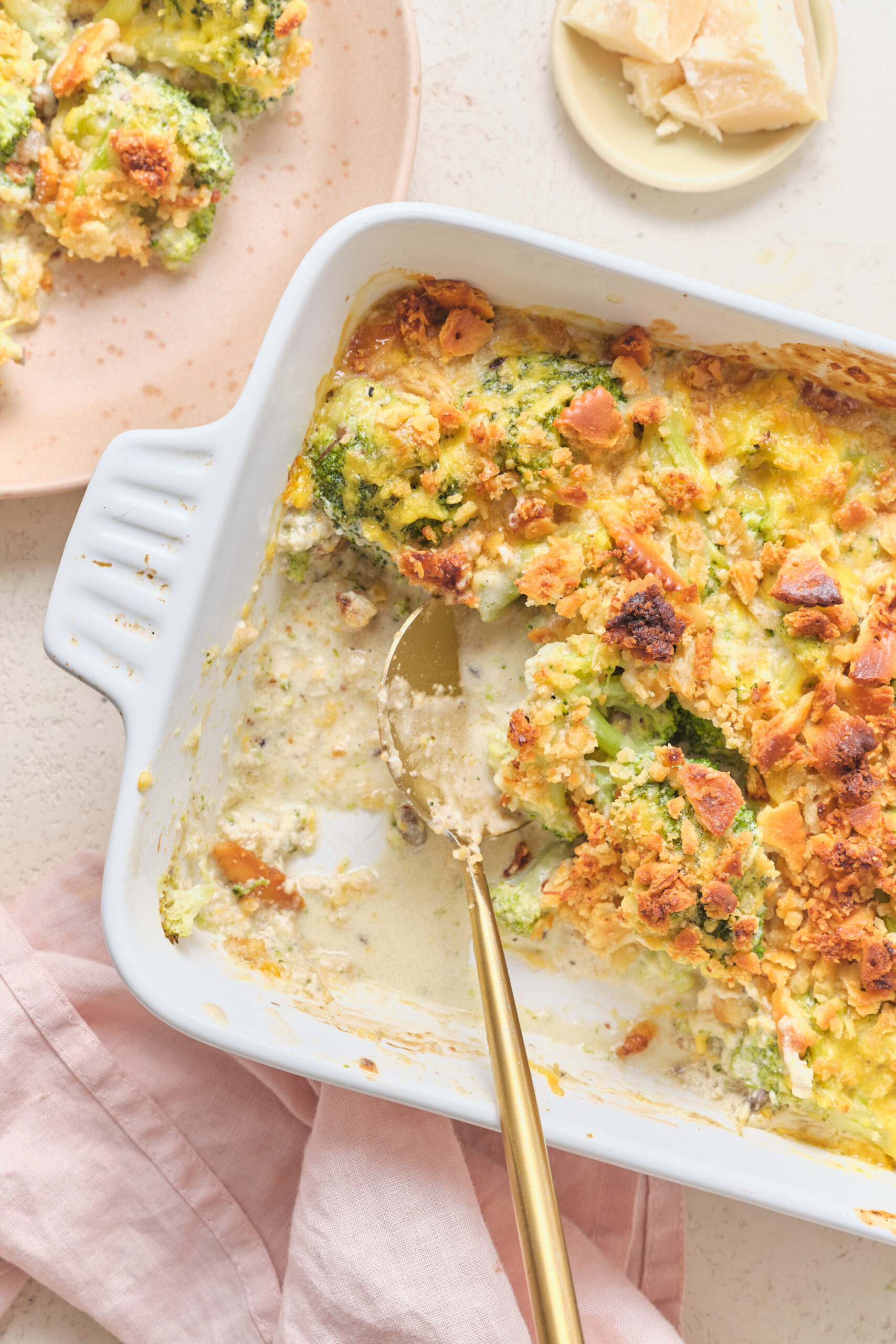 Broccoli Casserole With Ritz Crackers on a baking dish with a serving spoon shot from above